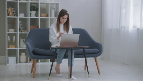 woman-is-working-remotely-by-internet.-Happy-young-business-woman-wears-headset-talks-to-web-camera-making-distance-online-video-conference-call.-Female-internet-teacher-doing-distant-chat-working